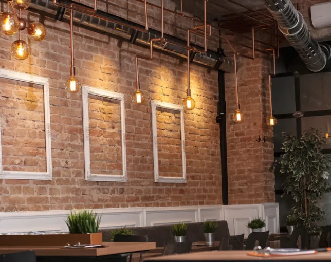 A restaurant with a brick wall and lots of windows